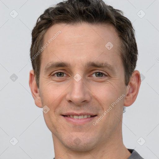 Joyful white adult male with short  brown hair and grey eyes