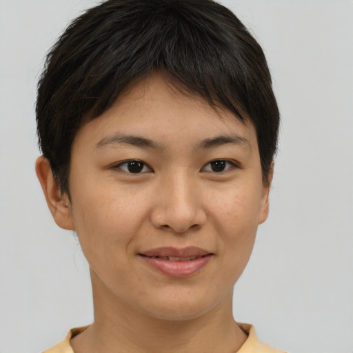 Joyful asian young-adult female with short  brown hair and brown eyes