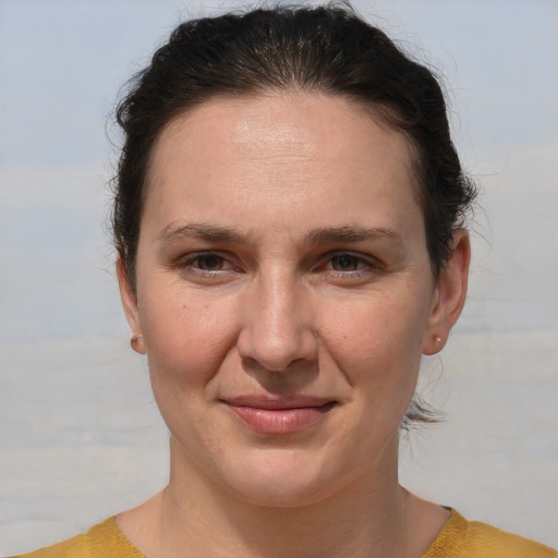 Joyful white adult female with medium  brown hair and brown eyes