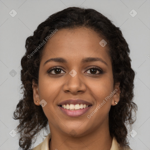 Joyful black young-adult female with long  brown hair and brown eyes