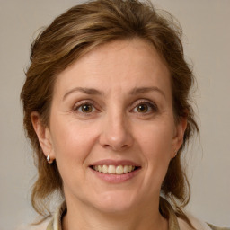 Joyful white adult female with medium  brown hair and grey eyes