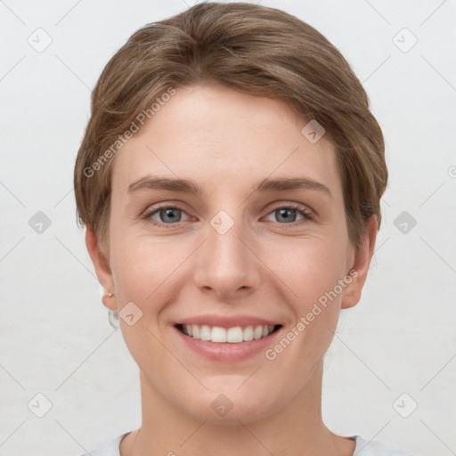 Joyful white young-adult female with short  brown hair and grey eyes