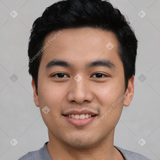 Joyful asian young-adult male with short  black hair and brown eyes