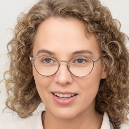 Joyful white adult female with medium  brown hair and blue eyes