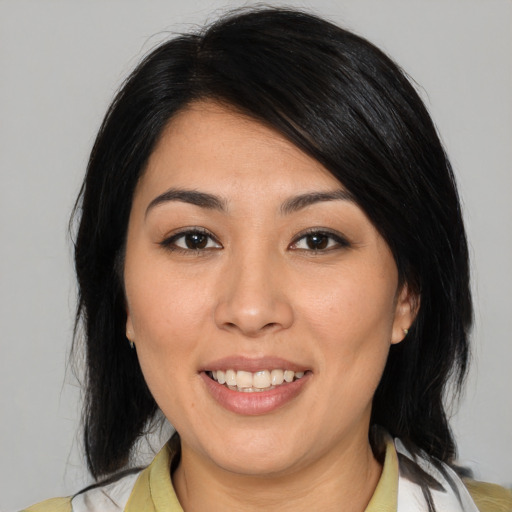 Joyful asian young-adult female with medium  black hair and brown eyes