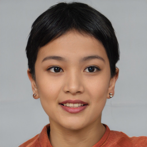 Joyful asian young-adult female with short  brown hair and brown eyes