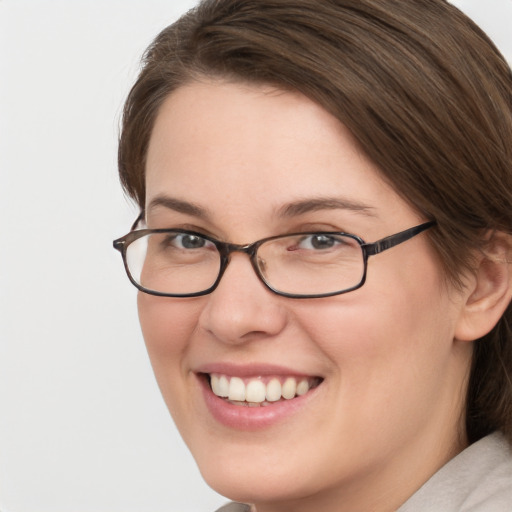 Joyful white young-adult female with medium  brown hair and green eyes