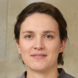 Joyful white young-adult female with medium  brown hair and grey eyes