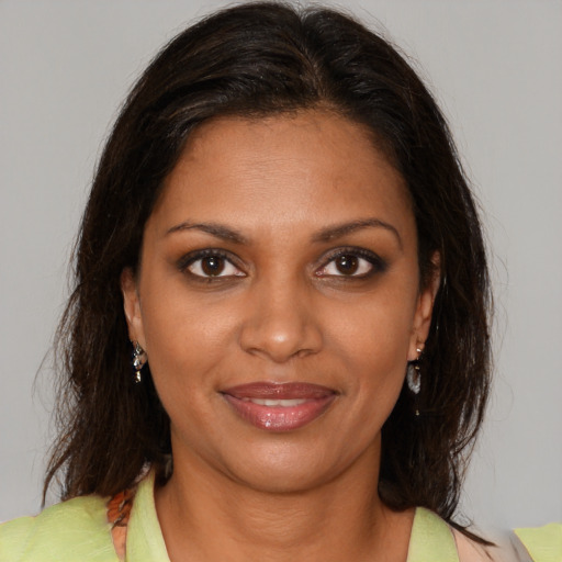 Joyful black young-adult female with medium  brown hair and brown eyes
