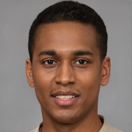Joyful black young-adult male with short  brown hair and brown eyes