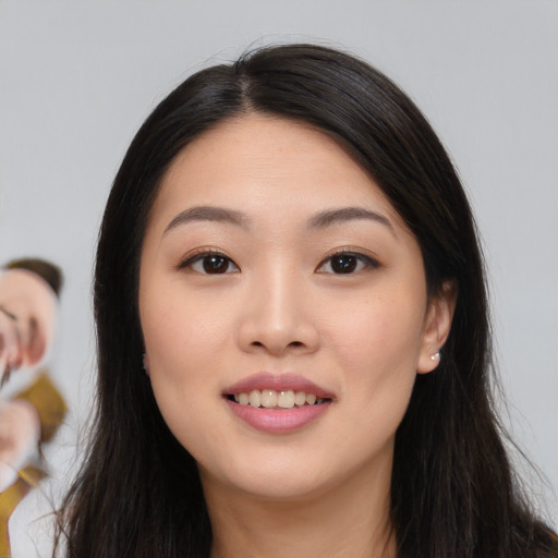 Joyful asian young-adult female with long  black hair and brown eyes