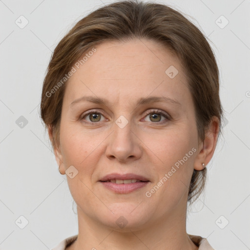 Joyful white adult female with medium  brown hair and grey eyes