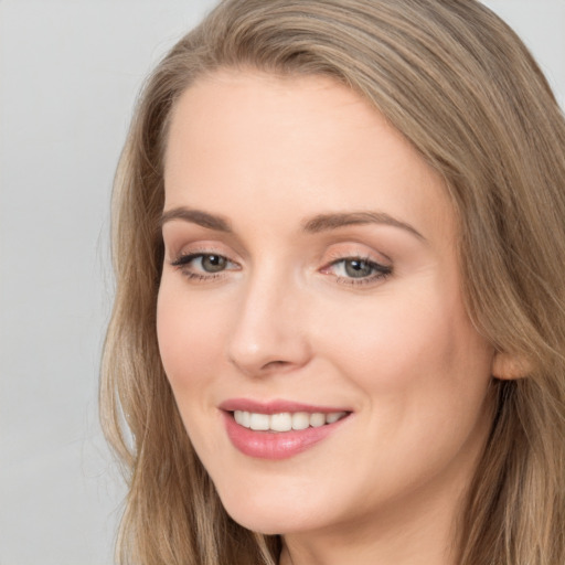 Joyful white young-adult female with long  brown hair and grey eyes