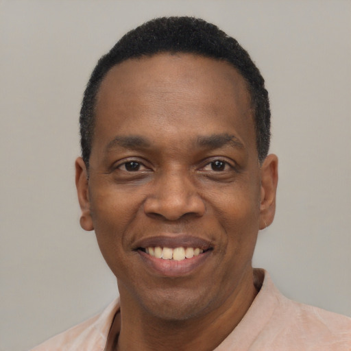 Joyful black adult male with short  black hair and brown eyes