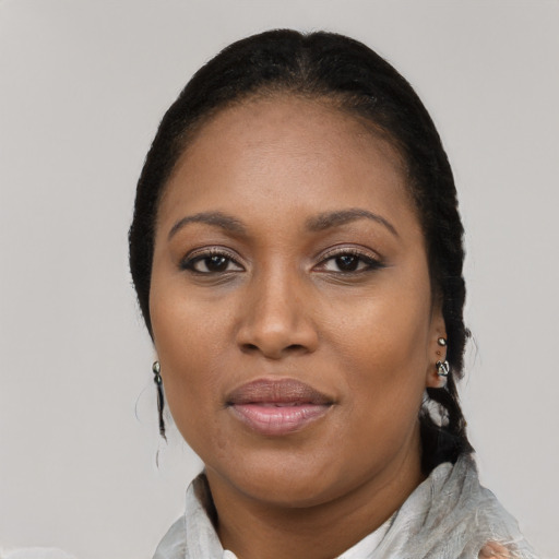 Joyful black adult female with medium  black hair and brown eyes
