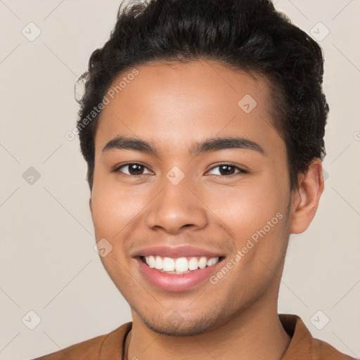 Joyful latino young-adult male with short  brown hair and brown eyes