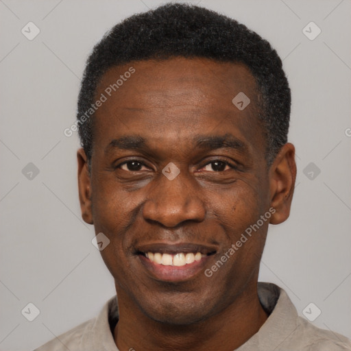 Joyful black adult male with short  black hair and brown eyes