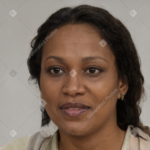 Joyful black adult female with medium  brown hair and brown eyes