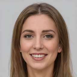 Joyful white young-adult female with long  brown hair and green eyes