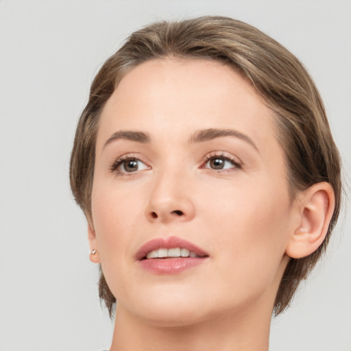 Joyful white young-adult female with medium  brown hair and grey eyes