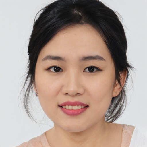 Joyful asian young-adult female with medium  brown hair and brown eyes
