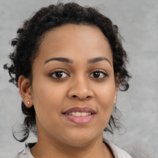 Joyful black young-adult female with medium  brown hair and brown eyes