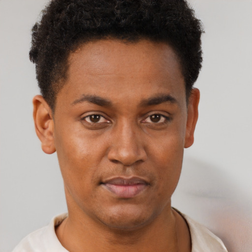 Joyful black young-adult male with short  brown hair and brown eyes