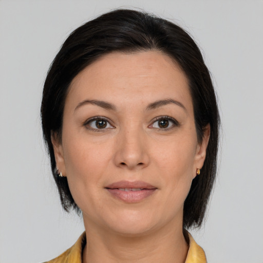 Joyful white adult female with medium  brown hair and brown eyes