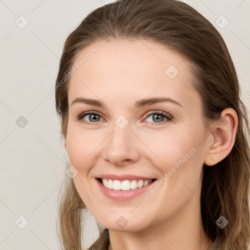 Joyful white young-adult female with long  brown hair and grey eyes