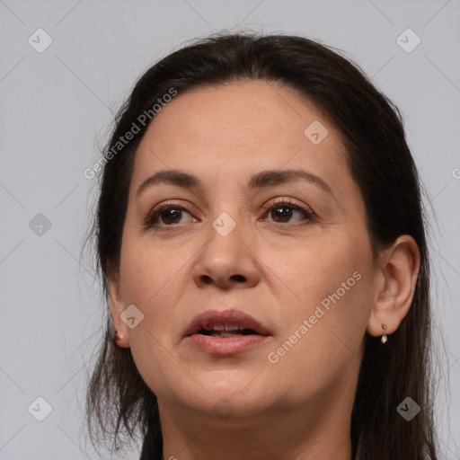 Joyful white adult female with long  brown hair and brown eyes