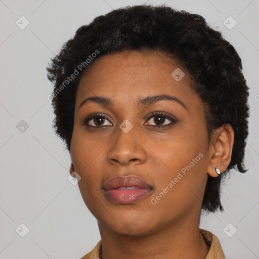 Joyful black young-adult female with short  black hair and brown eyes