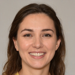 Joyful white young-adult female with medium  brown hair and brown eyes