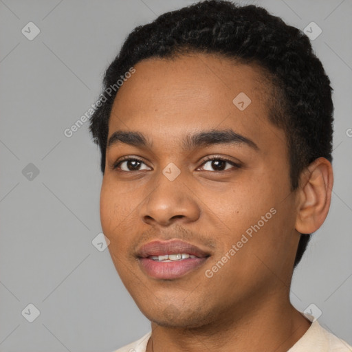 Joyful black young-adult male with short  black hair and brown eyes