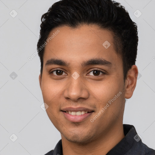 Joyful latino young-adult male with short  brown hair and brown eyes