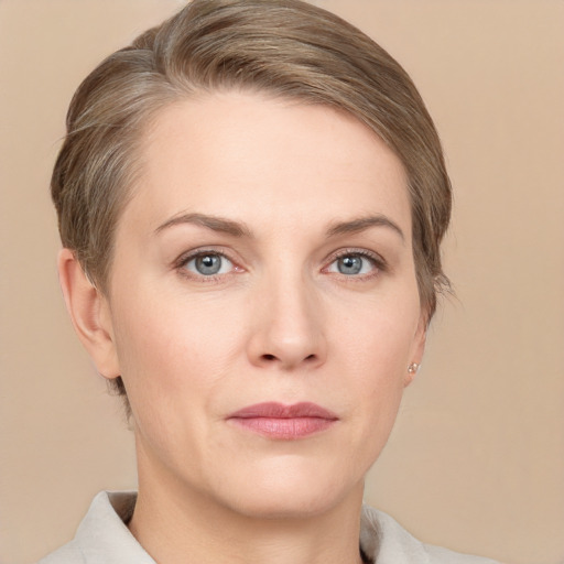 Joyful white young-adult female with short  brown hair and grey eyes