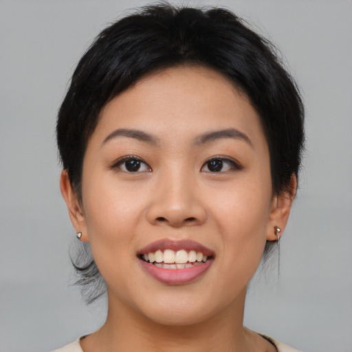 Joyful asian young-adult female with medium  brown hair and brown eyes