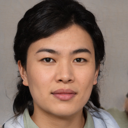 Joyful asian young-adult female with medium  brown hair and brown eyes