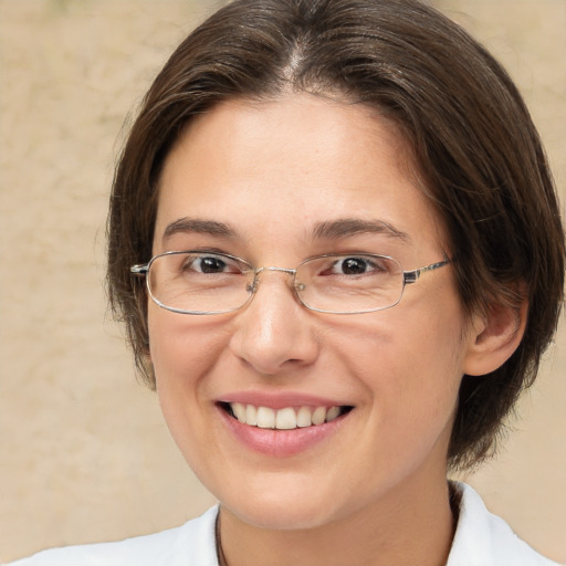 Joyful white adult female with medium  brown hair and brown eyes