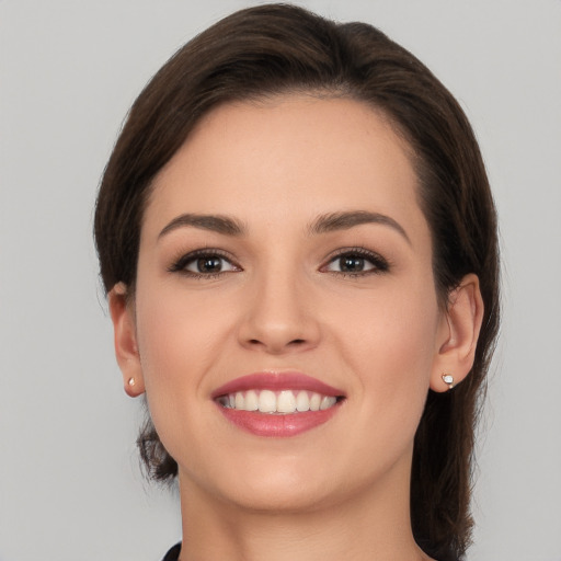 Joyful white young-adult female with medium  brown hair and brown eyes