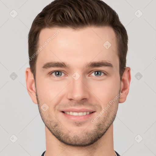 Joyful white young-adult male with short  brown hair and grey eyes