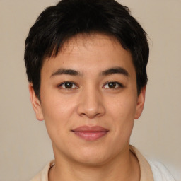 Joyful asian young-adult male with short  brown hair and brown eyes