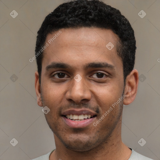 Joyful black young-adult male with short  black hair and brown eyes