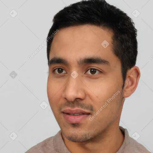 Joyful latino young-adult male with short  black hair and brown eyes