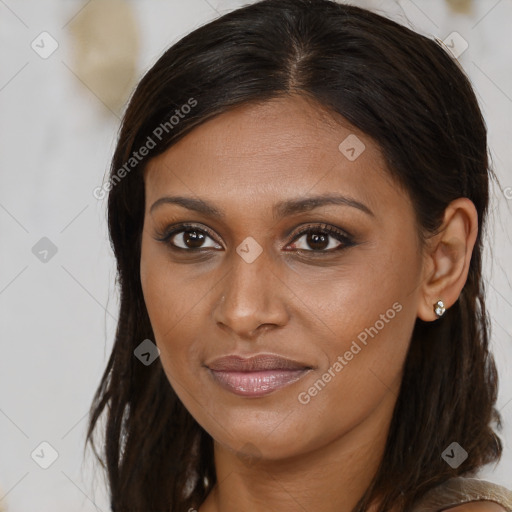 Joyful black young-adult female with long  brown hair and brown eyes