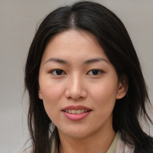 Joyful asian young-adult female with long  brown hair and brown eyes