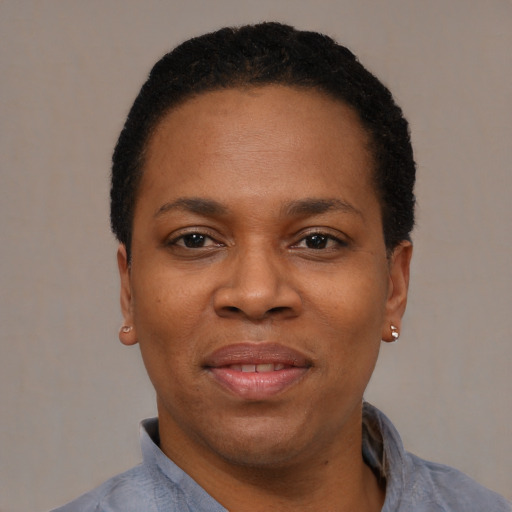 Joyful black adult female with short  black hair and brown eyes