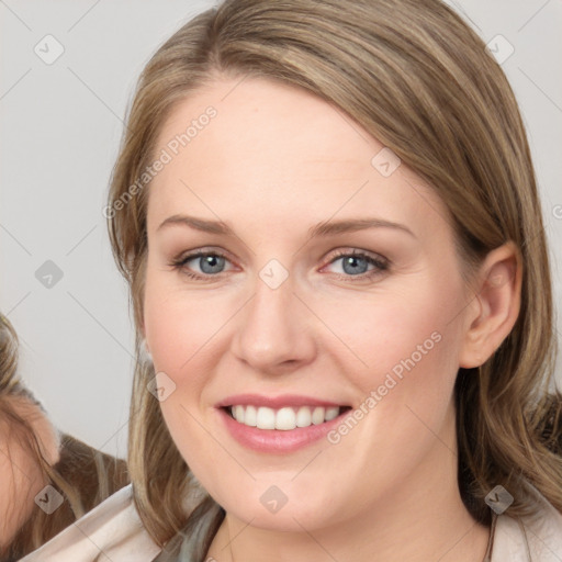 Joyful white young-adult female with medium  brown hair and blue eyes