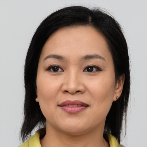 Joyful asian young-adult female with medium  brown hair and brown eyes