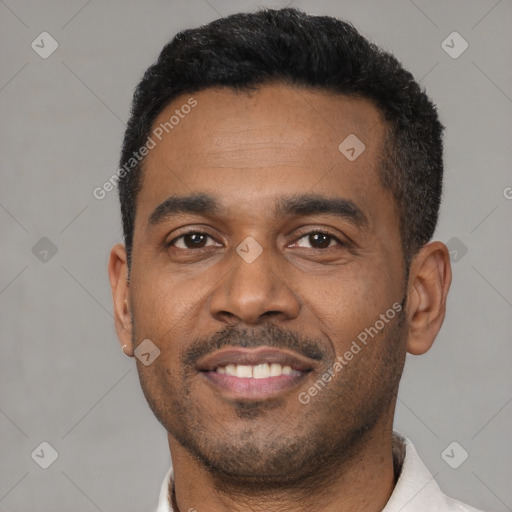 Joyful latino young-adult male with short  black hair and brown eyes