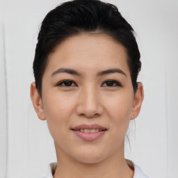 Joyful asian young-adult female with short  black hair and brown eyes